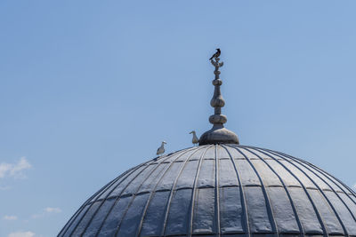 Low angle view of a building against blue sky