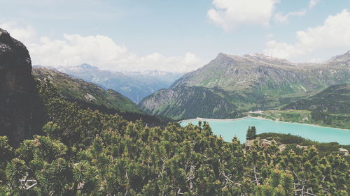 Scenic view of mountains against cloudy sky