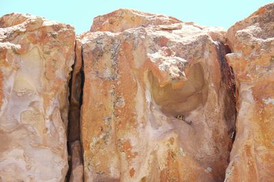 Close-up of rock formation against sky