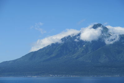 Scenic view of sea and mountains against sky