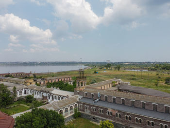 High angle view of townscape by sea against sky