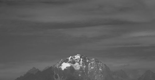 Low angle view of snowcapped mountain against sky