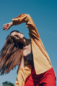 Low angle view of woman against sky