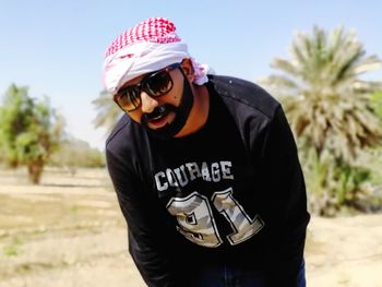 Portrait of man wearing hat standing outdoors