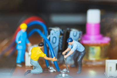 Close-up of figurine on multi colored background