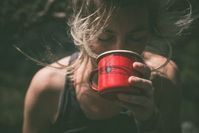 Close-up of woman drinking from cup