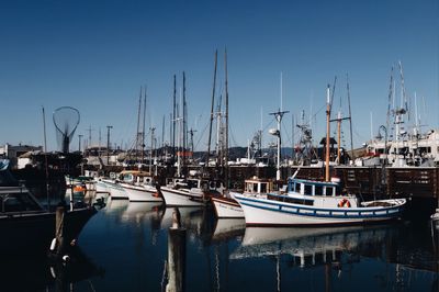 Boats moored at harbor
