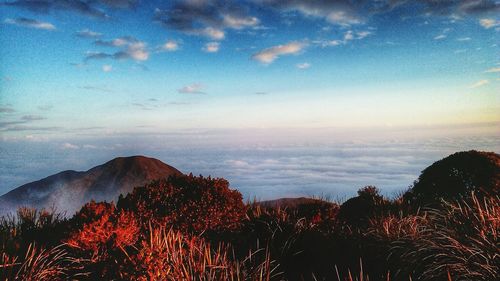 Scenic shot of mountain range against clouds