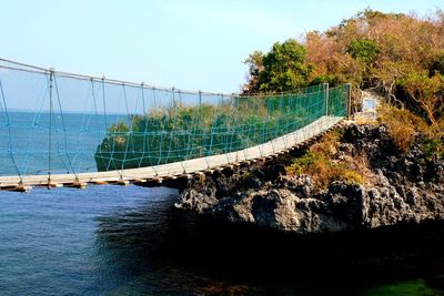 Bridge over sea against sky