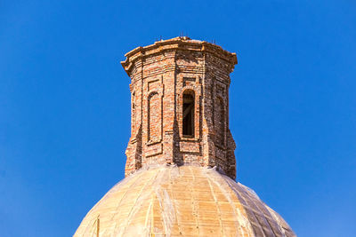 Low angle view of historical building against blue sky