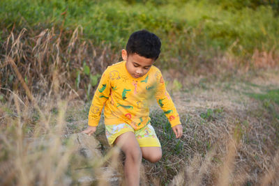 Boy standing on field