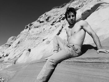 Portrait of young man on rock