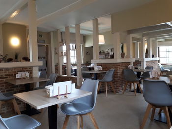 Empty chairs and tables in restaurant