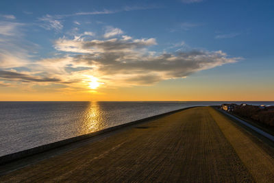 View of sea against cloudy sky during sunset