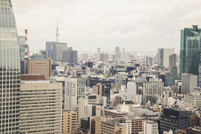 Aerial view of modern buildings in city against sky