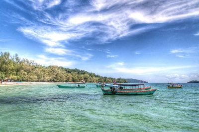 Boats sailing in sea against sky