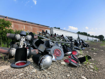 Abandoned road signals on field against sky