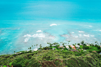 High angle view of land and sea against sky