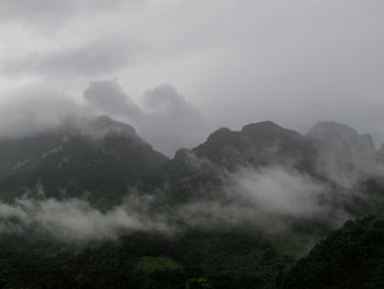 Scenic view of mountains against sky during foggy weather