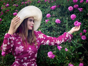 Portrait of a beautiful young woman with pink flowers