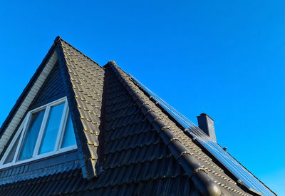 Solar panels producing clean energy on a roof of a residential house