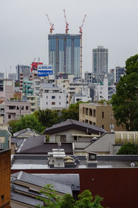 High angle view of buildings in city against sky