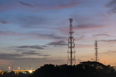 Low angle view of communications tower against sky at sunset