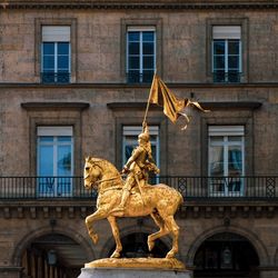 Low angle view of statue against building