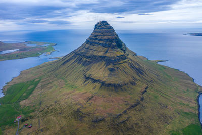 High angle view of rock formation by sea against sky