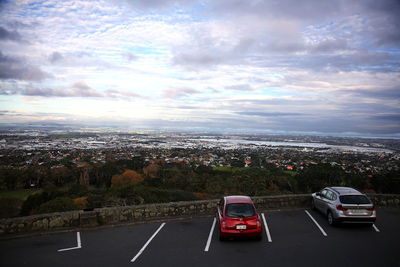 Cars on road in city against sky