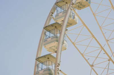 Low angle view of electricity pylon against clear sky