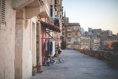 Street amidst buildings in city against clear sky