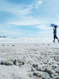 Man on beach against sky