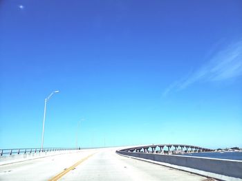 Empty road against blue sky