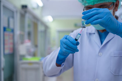 Midsection of person holding umbrella