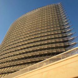 Low angle view of modern building against clear blue sky