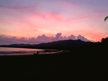 Scenic view of beach against dramatic sky