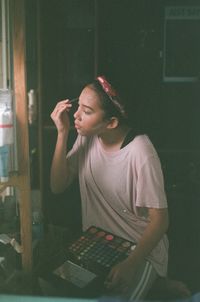 Young woman using mobile phone at home