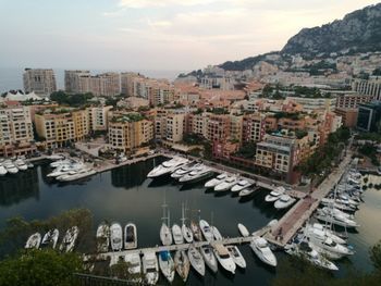 High angle view of boats moored in river against buildings