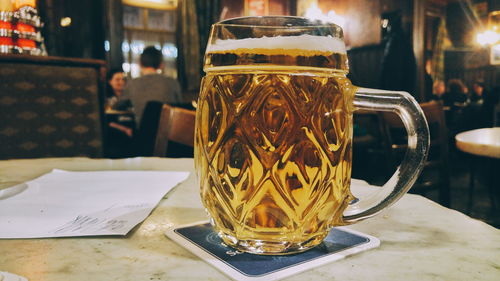 Close-up of beer glass on table