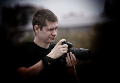 Young photographer holding dslr camera