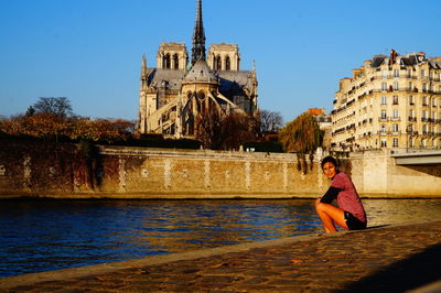 Woman with fountain in front of building