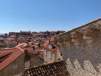 Low angle view of townscape against clear blue sky