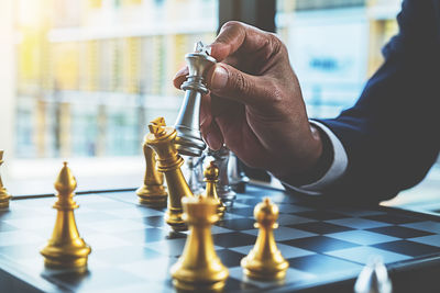 Low angle view of man playing on chess board