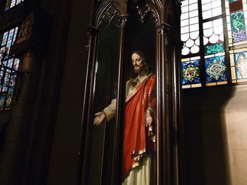 Man standing by window in temple