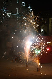 Low angle view of firework display at night