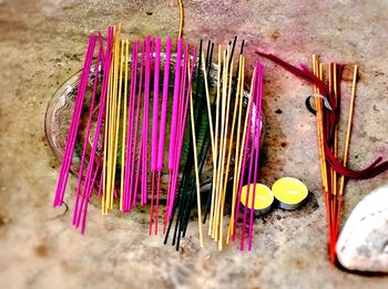 High angle view of multi colored pencils on sand