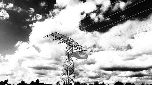 Low angle view of silhouette cranes against sky