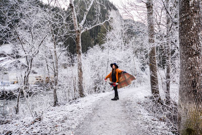 Full length of woman in winter forest