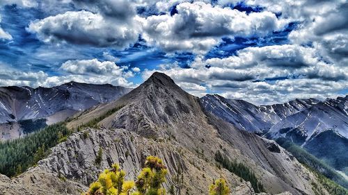 Panoramic view of mountain range against cloudy sky